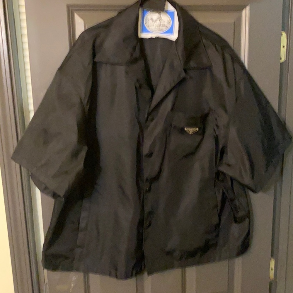 It’s a large Prada button up short sleeve black good Material